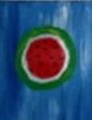 A watermelon is shown on the side of a blue wall.